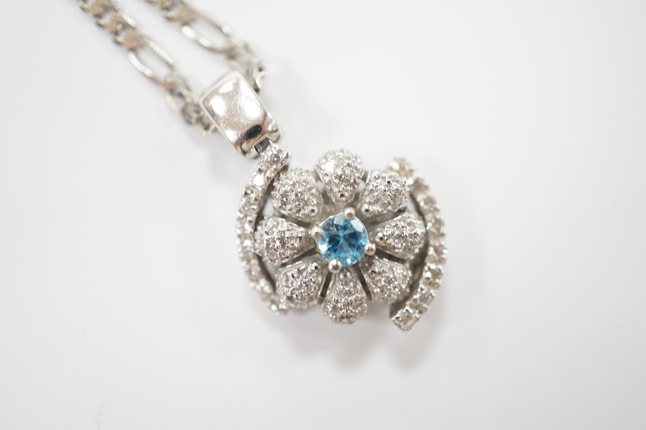 A modern 14ct gold, topaz? and simulated diamond chip cluster set pendant, 20mm, on a 9ct chain, 44cm, gross weight 11.2 grams